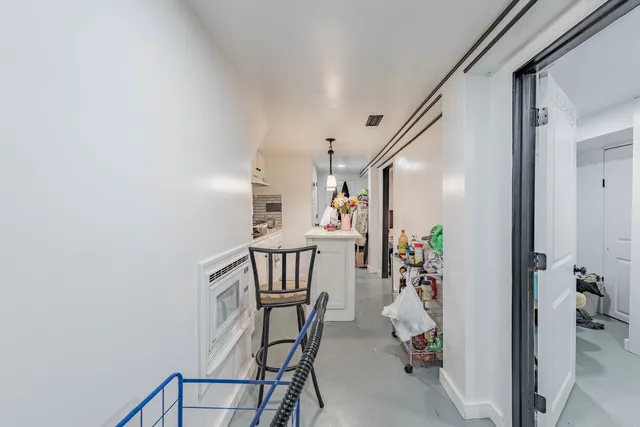 a view of a hallway with furniture and entryway