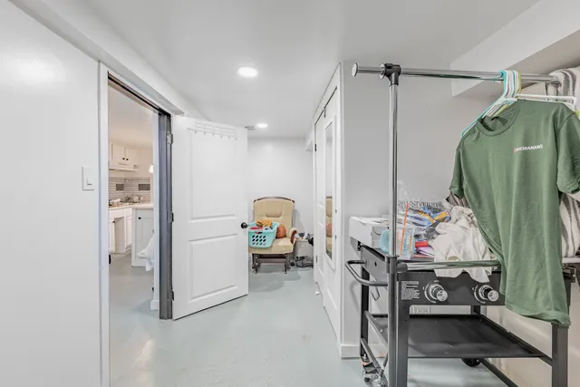 a view of walk in closet with clothes and shoes