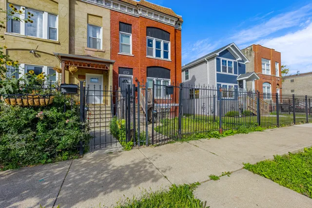 a view of a brick building next to a yard