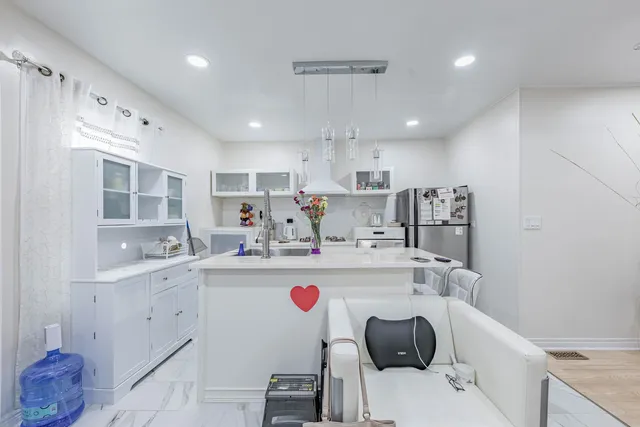 a kitchen with a sink a stove and cabinets