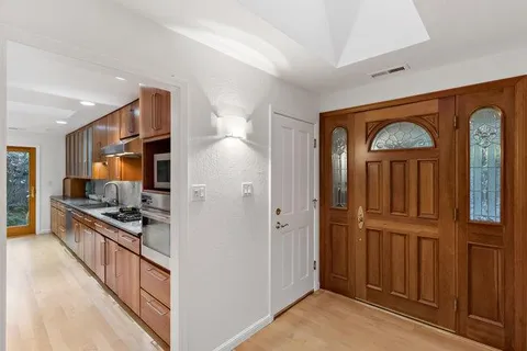 a large kitchen with stainless steel appliances granite countertop a sink and cabinets