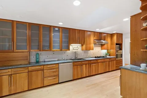 a view of a hallway with wooden floor and closet