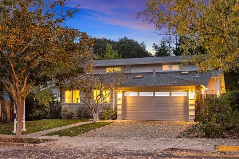 a front view of a house with a yard and an outdoor seating