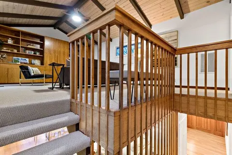 a living room with furniture a rug and a large window