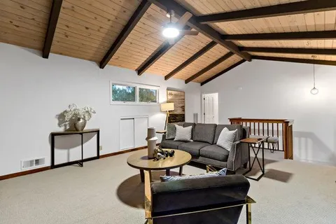 a bedroom with a bed and a mirror