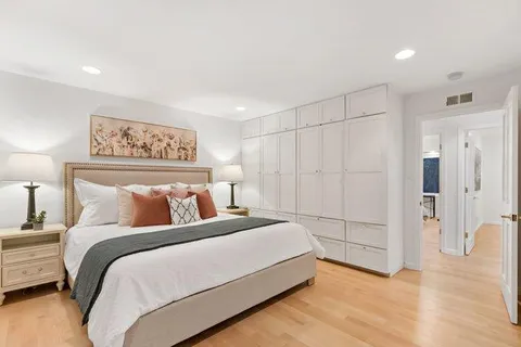 a bedroom with a bed and a chandelier