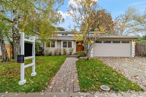 front view of a house with a tree