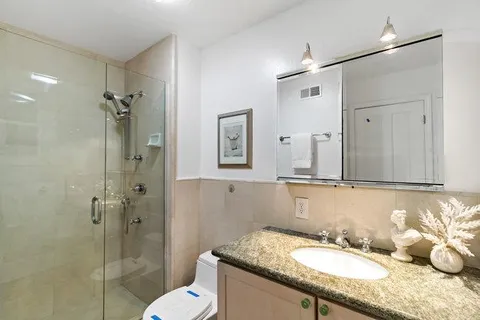 a view of walk in closet with clothes