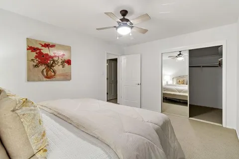 a bedroom with a bed and a large window