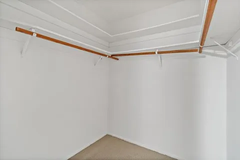 a bedroom with a bed and a lamp