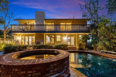 aerial view of a house with a yard and garden