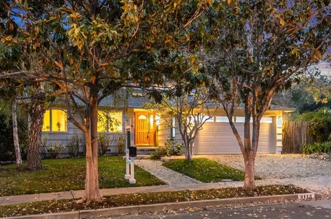 a living room with furniture fireplace and a table