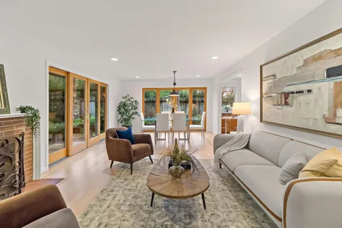 a living room with furniture and a floor to ceiling window