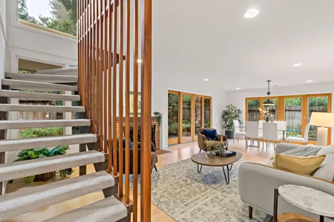 a living room with furniture a rug and white walls