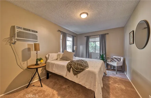 a bedroom with a large bed and a chandelier