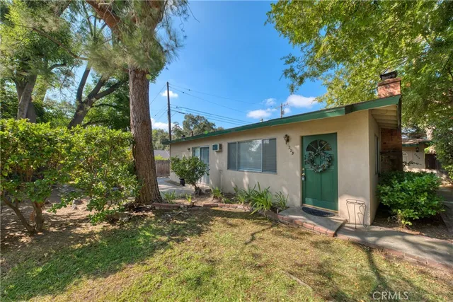 a view of a house with backyard and sitting area