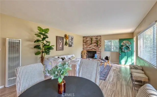 a living room with furniture fireplace and a large window