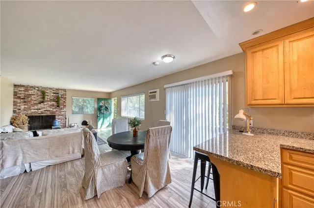 a living room with fireplace furniture and a large window