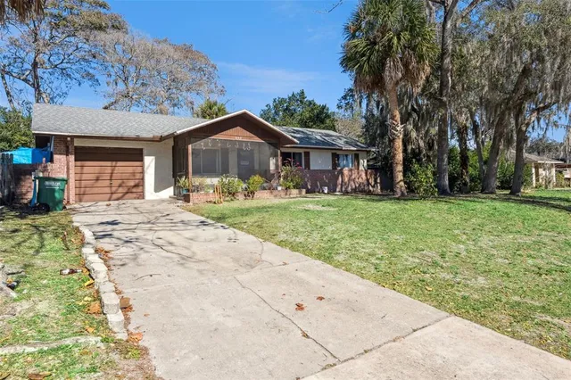 a front view of a house with a yard and trees