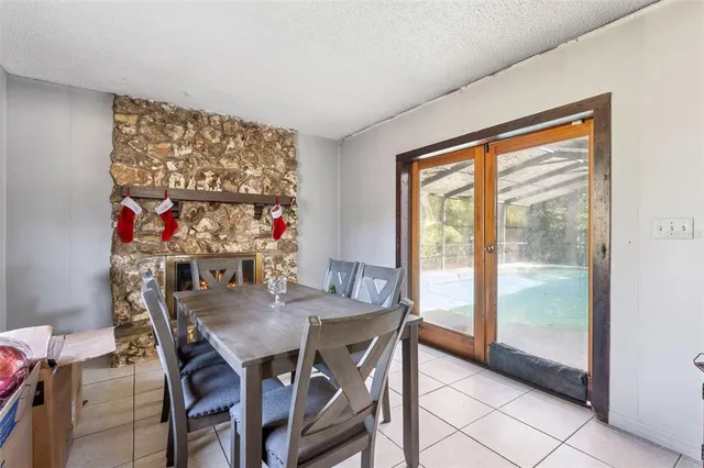 a view of a dining room with furniture large window and outside view