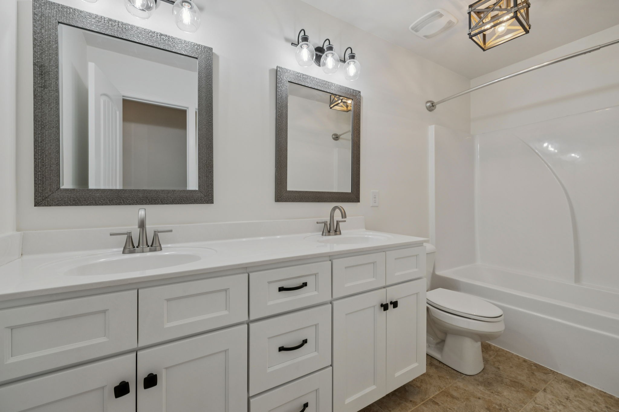 2002 Virgle Circle Spring Hill, TN 37174 - Photo 31 of 44 a bathroom with a toilet a sink a mirror and a bathtub