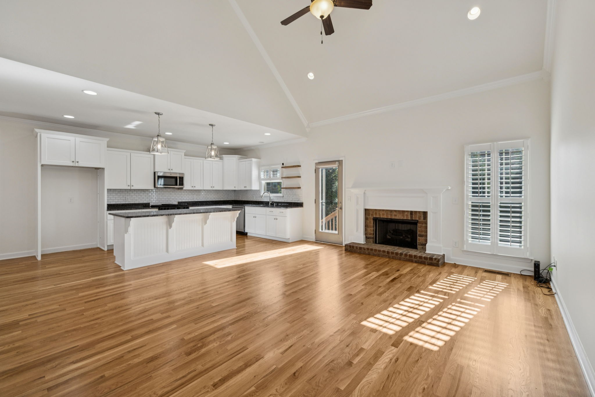 2002 Virgle Circle Spring Hill, TN 37174 - Photo 8 of 44 a view of kitchen with granite countertop a stove top oven a sink and a fireplace