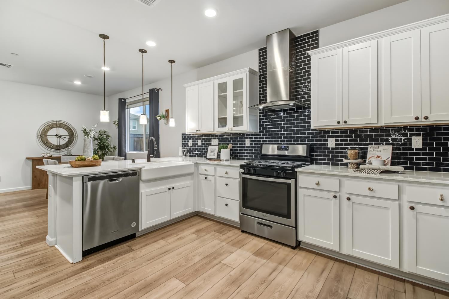 a kitchen with a stove cabinets and wooden floor