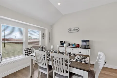 a view of a dining room with furniture and window