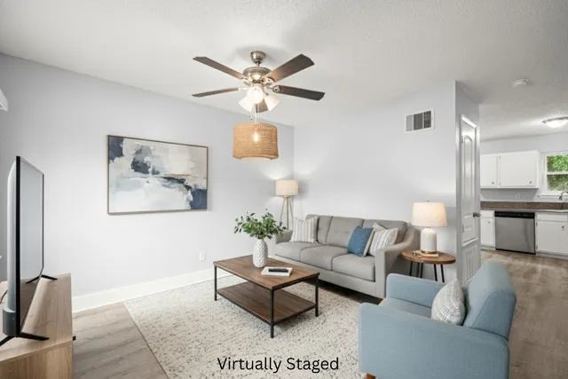 a living room with furniture and a flat screen tv