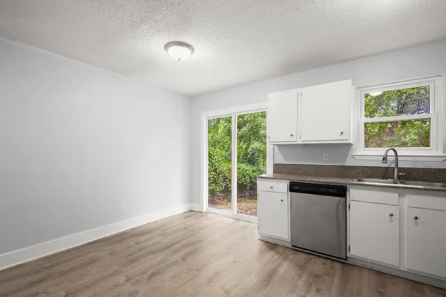 a kitchen with a sink cabinets appliances and a window