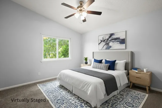 a bedroom with a bed and a painting on the wall