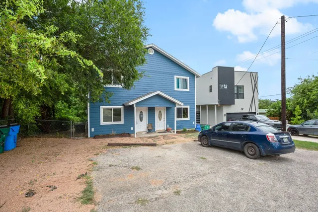 a view of a car parked in front of a house