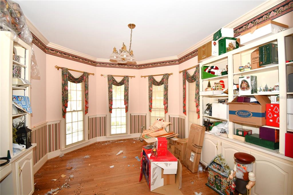 600 Old Eustis Road Mount Dora, FL 32757 - Photo 15 of 29 a bedroom with furniture and a chandelier