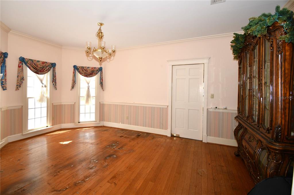 600 Old Eustis Road Mount Dora, FL 32757 - Photo 9 of 29 a view of empty room with wooden floor and fan