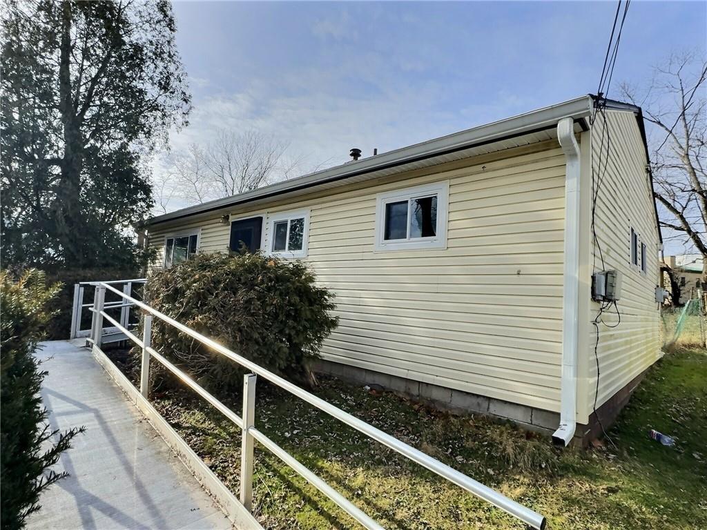 a view of a house with backyard and wooden deck