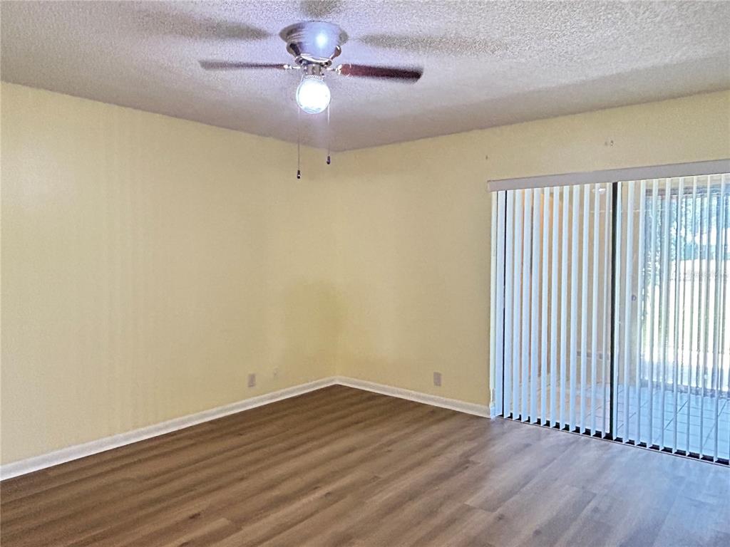2274 Firestone Place Winter Haven, FL 33884 - Photo 12 of 25 wooden floor in an empty room with a window