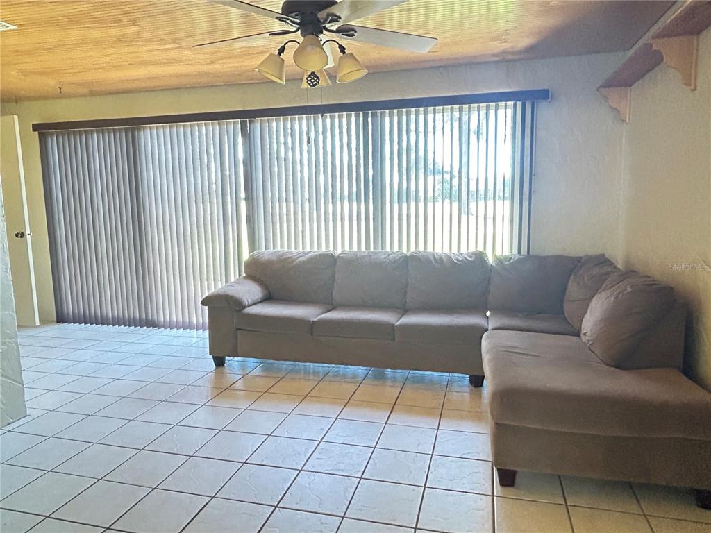 2274 Firestone Place Winter Haven, FL 33884 - Photo 15 of 25 a living room with furniture and a window