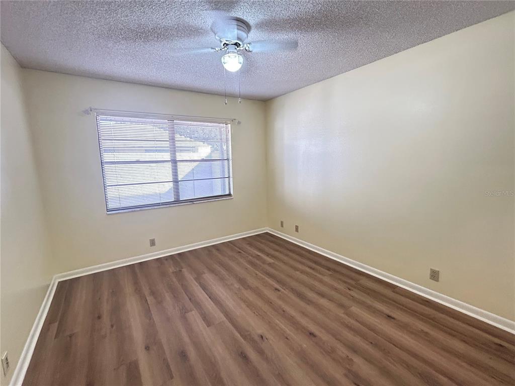 2274 Firestone Place Winter Haven, FL 33884 - Photo 24 of 25 wooden floor in an empty room with a window