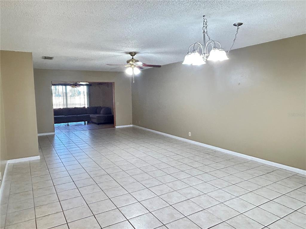 2274 Firestone Place Winter Haven, FL 33884 - Photo 6 of 25 wooden floor in an empty room with a window