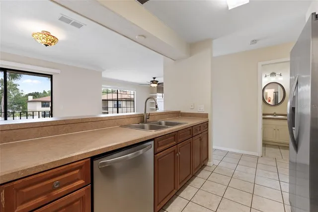 a kitchen with stainless steel appliances granite countertop a sink and a cabinets