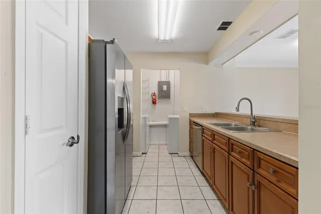 a en suite bathroom with a granite countertop sink and a mirror