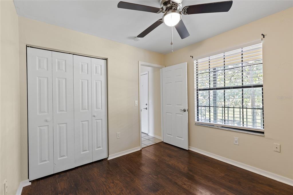 6400 Northwest 106th Place, Unit 20 Alachua, FL 32615 - Photo 24 of 40 a view of an empty room with wooden floor and a window