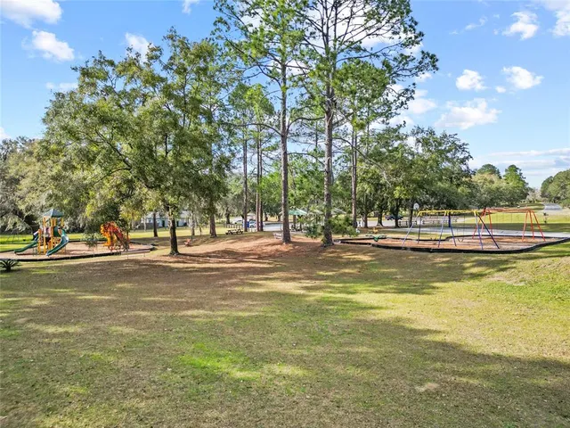 an aerial view of a house with a swimming pool yard and outdoor seating