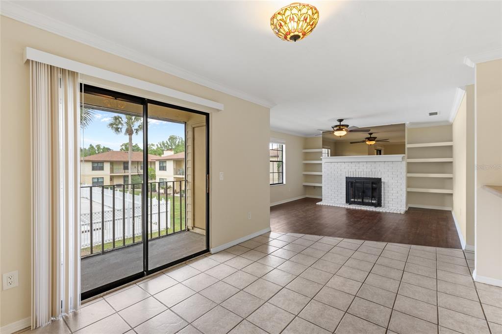 6400 Northwest 106th Place, Unit 20 Alachua, FL 32615 - Photo 9 of 40 a view of an empty room with a fireplace and a window