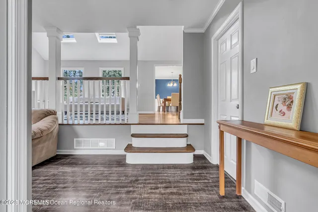 a view of entryway and hall with wooden floor