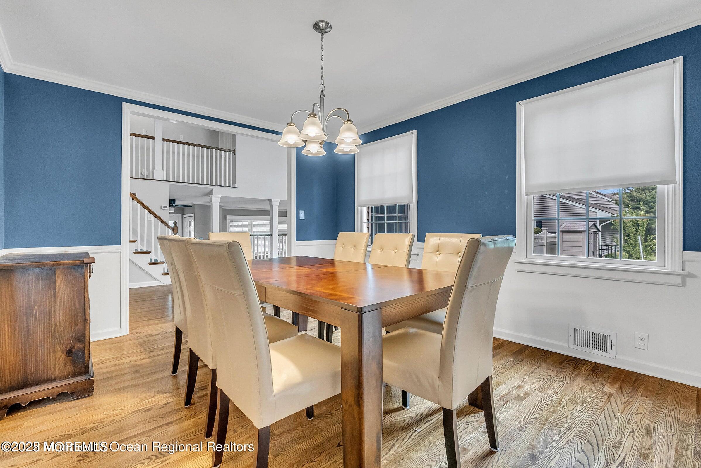 1 Barbara Lane Oakhurst, NJ 07755 - Photo 5 of 8 a dining room with furniture a chandelier and wooden floor