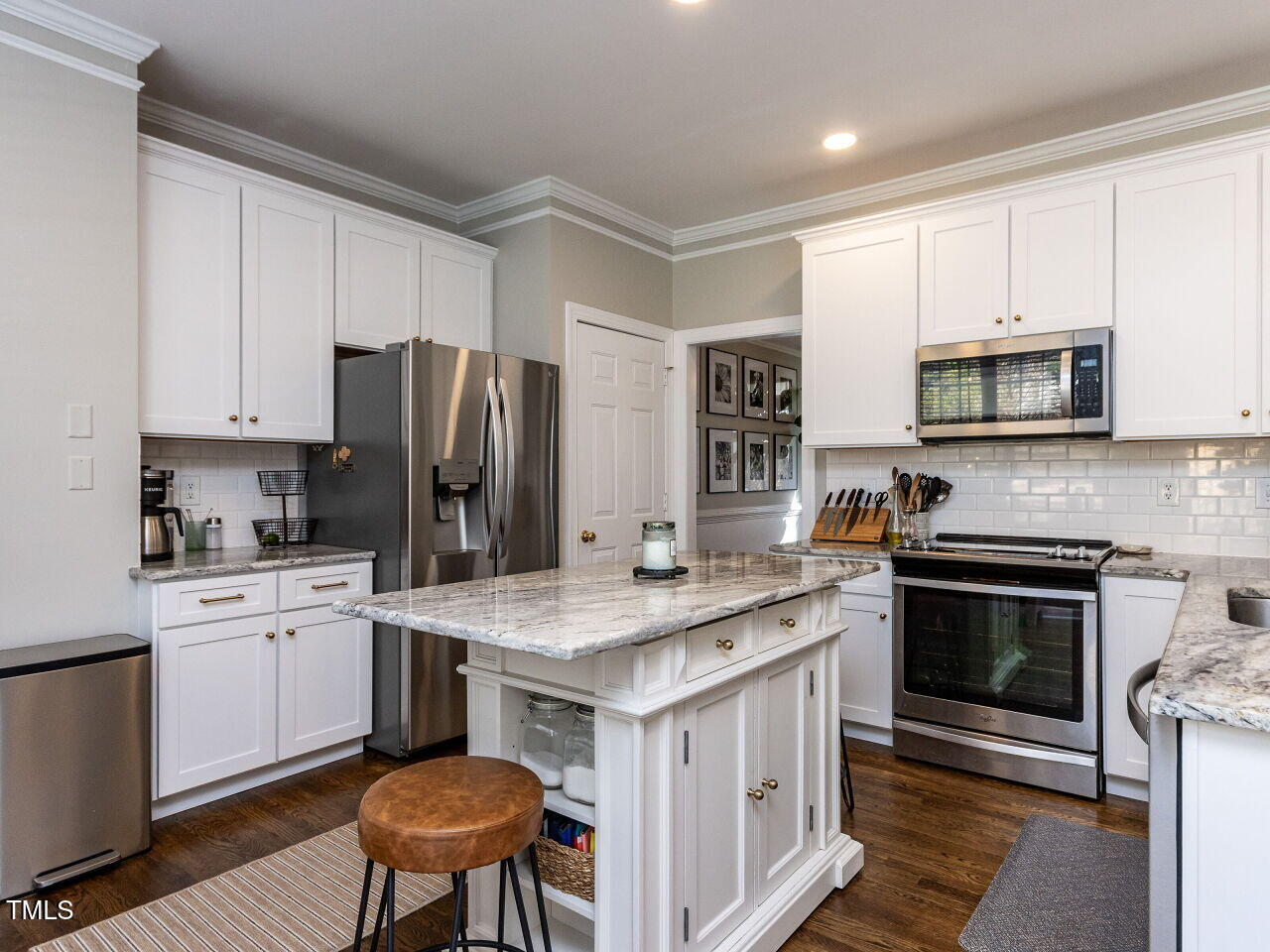 2019 Falls River Avenue Raleigh, NC 27614 - Photo 12 of 40 Remodeled Kitchen with white custom cabinets, white backsplash, attractive granite and ss appliances.