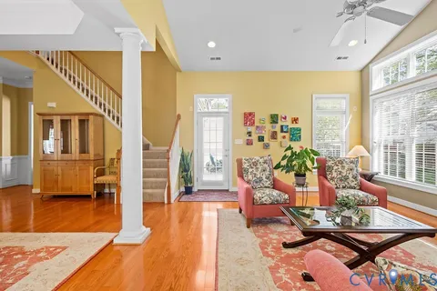 a view of a dining room with furniture and a chandelier