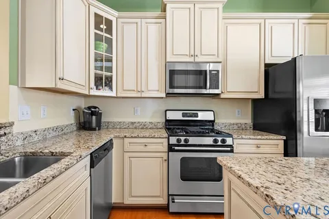 a kitchen with stainless steel appliances granite countertop a stove and a sink
