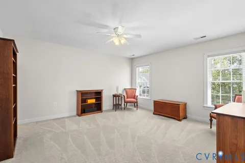 a view of a livingroom with furniture and a window